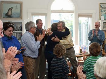 Rick Bates hugs Ann Filley, after naming her the new library director Friday afternoon. (Photo by Holly S. Edwards)