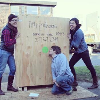 The Fox i Printworks crew posing with their letterpress, which arrived on the island from Rockland. (Photo courtesy Fox i Printworks)
