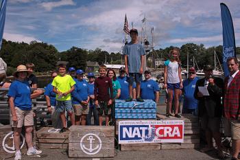 Winners of the 2014 Camden Windjammer Festival Lobster Crate Race stand atop the crate podium Saturday. Taking first place was Emerson Brott, 288 crates, second place went to Lauren Rothwell, 286 crates, and there was a tie for third place between Jonah Lovejoy and Luke Drinkwater, who both tallied 270 crates. (Photo by Holly S. Edwards)