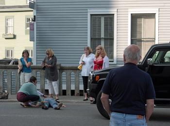Bystanders - including a physician who was stopped at the intersection adjacent to the vehicle that then struck Jeanne Murphy of Baltimore - render comfort and first aid minutes before first responders and an ambulance arrive on scene. (Photo by Holly S. Edwards)