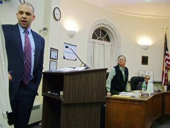 City Councilor Roger Lee, right, stands to get a view of a presentation by Economic Development Director Thomas Kittredge earlier this year. The four-term councilor from Ward 2 listed the creation of Kittredge’s position and other business-boosting investments as defining work by the Council in recent years. (Photo by Ethan Andrews)