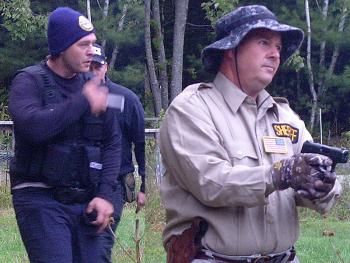 Police have identified the man in the back on the left, whose face is obscured, as Kerry Hurd, 45, of Bangor. A warrant has been issued for his arrest and they are seeking to public’s help in locating him. Hurd’s alleged accomplices, Scott Roberts, left, and his brother, Jeffrey Hurd, right turned themselves into the Waldo County Jail in Belfast Oct. 1 after learning they had been identified and arrest warrants had been issued. Roberts and Jeffrey Hurd live in Glenburn. (Courtesy Maine State Police)