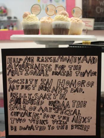Jacob Murray spent a long afternoon writing, and rewriting, this sign to announce his Brain Cupcake fundraiser two weeks ago. (Photo by Holly S. Edwards)