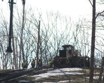The chairlift tower is slowly delivered to the crew on the mountain. (Photo by Holly S. Edwards)