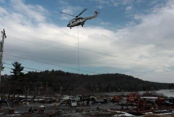 Lifting another tower up out of the Snow Bowl parking lot. (Photo by Holly S. Edwards)
