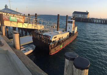The sun goes down Monday on the Camden sailors, their Winnie bunkhouse and the barge ‘Clam,’ tied up at a dock in Provincetown, Mass. (Courtesy Steve Pixley)