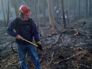 Lincolnville firefighter Don Fullington Jr. works on the woods fire on Islesboro Wednesday night. (Courtesy Ben Hazen)