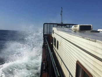 Riding the waves between Monhegan Island and Provincetown, Mass. yesterday is a 1987 Winnebago American Cobra camper aboard a 1966 steel barge called ‘Clam.’ (Courtesy Steve Pixley)