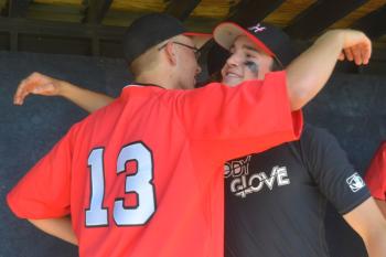Matt Crockett, right, gets a big hug from Daulton Wickenden after the game Saturday. Crockett leaves at 1 p.m. Sunday for the Marines. (Photo by Ron Hawkes)