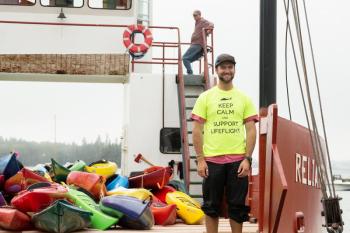 How do more than 100 kayaks get back to the mainland? This year volunteers from Island Transporter, with their boat, Reliance, were on hand to make that job efficient and effective. (Photo courtesy Michele Barker)