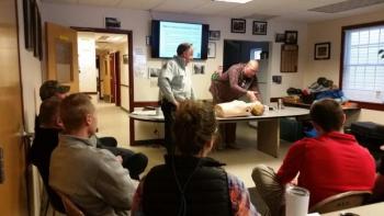 Justin Hills, paramedic and police officer, conducted the training on Jan. 17 for Camden and Rockport police and firefighters. In the photo, Hills is demonstrating how to administer Narcan on a practice dummy before Camden Fire Chief Chris Farley applies the proper technique. (Photo by Sarah Shepherd)