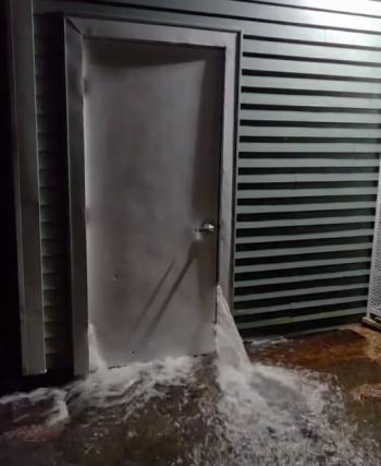 Water pours from a door in the Athletics Garage at Camden Hills Regional High School. (Photo courtesy SAD 28) c