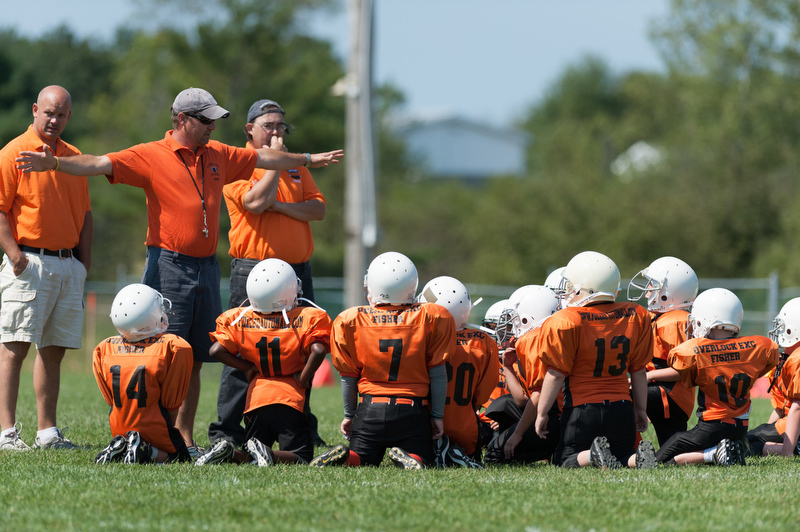 Rockland Tiger Cubs listen to coaches before the game. Photo by Ron Hawkes