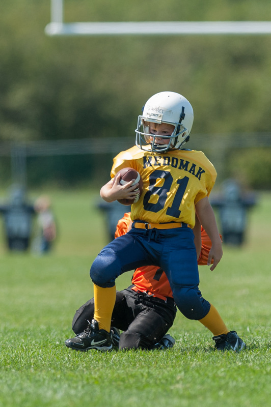 Medomak's Garrett Hutchins gets brought down from behind. Photo by Ron Hawkes