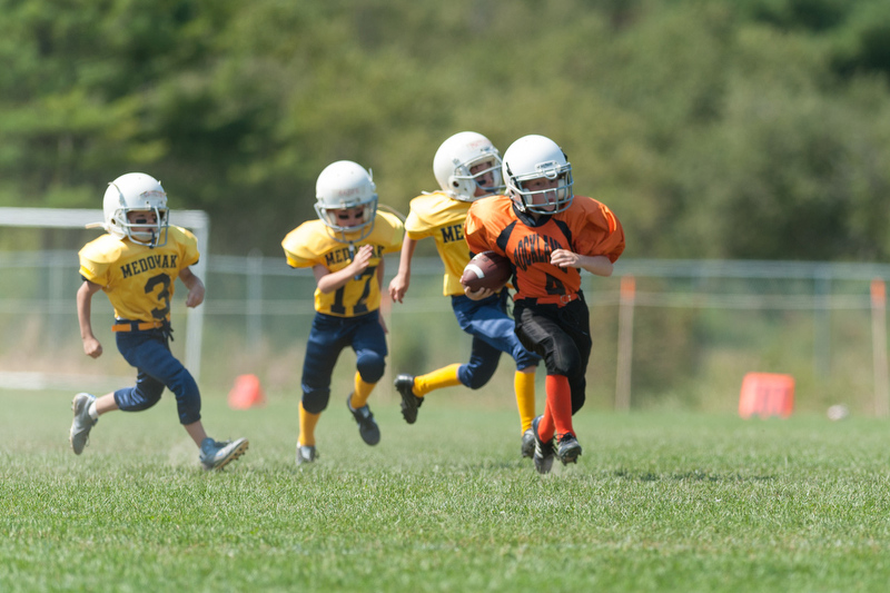 Three Medomak players race after a Rockland Tiger as he goes for the score. Photo by Ron Hawkes