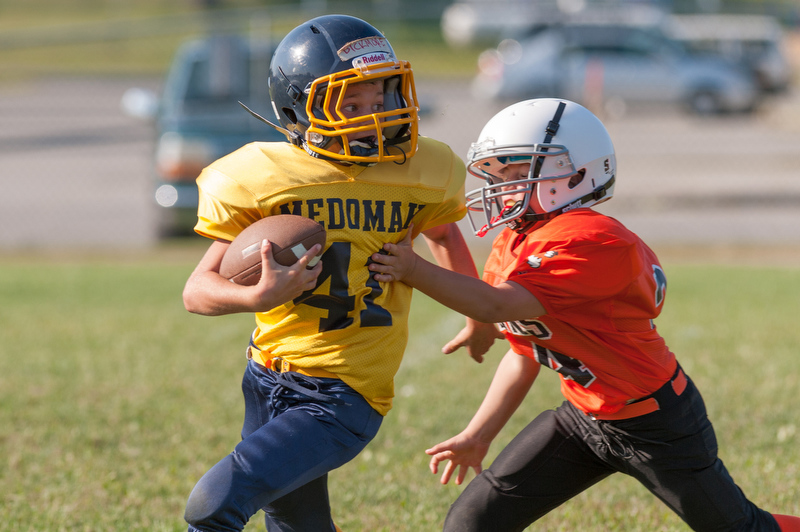 A Medomak runner gets tackled by a Rockland defender. Photo by Ron Hawkes