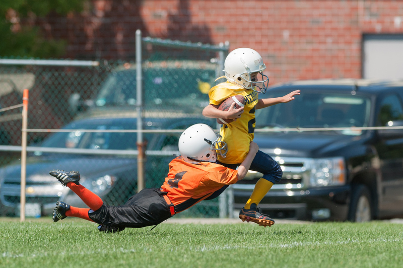 Rockland's Tiger Cub Austin Chilles makes a last minute driving tackle on a Medomak runner during the Cubs peewee scrimmage game. Photo by Ron Hawkes