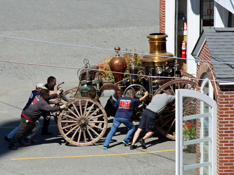 After moving the antique steam fire pumper out of its viewing room at the Camden Fire Station Tuesday, it's pushed back into a bay at the fire station.