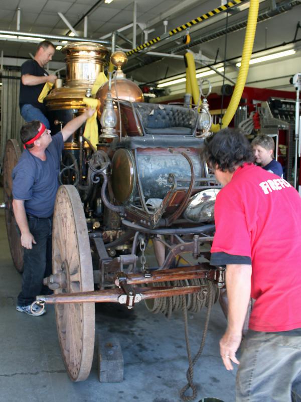 Camden firefighters join with Andy Swift of Firefly Restorations in sprucing up the town's antique horse-drawn steam fire pumper as a way to do something good on the anniversary of 9/11.