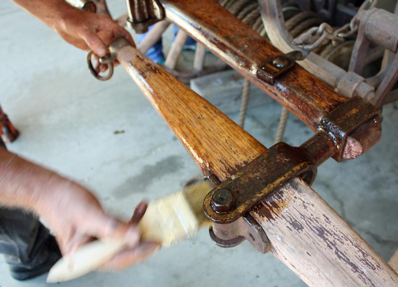 A coat of boiled linseed oil helps preserve the wood and the original paint on the whiffle tree of Camden's 1892 horse-drawn steam fire pumper.