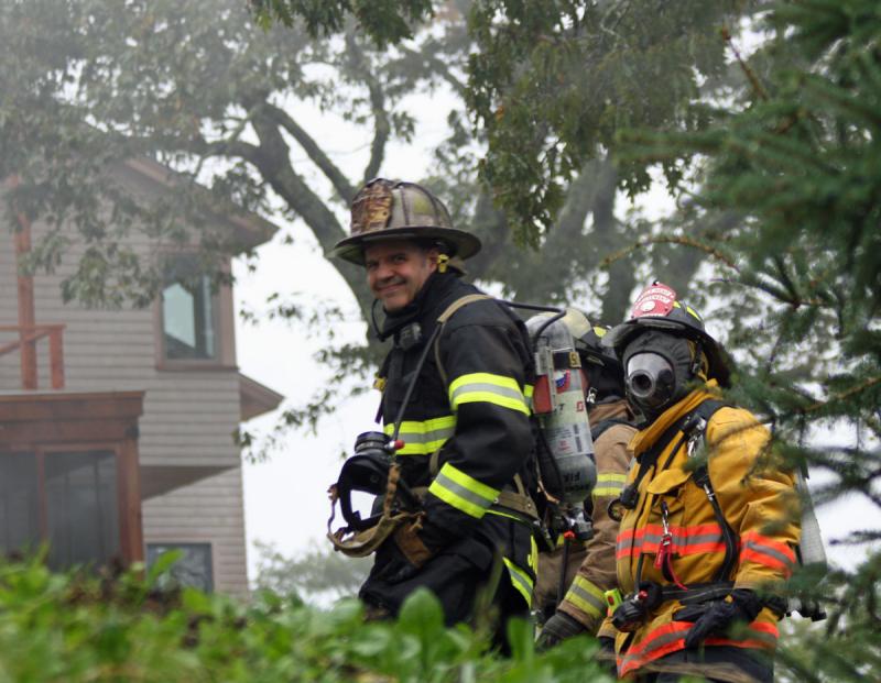 Rockland Fire Chief Charlie Jordan takes a turn venting at the back of the house Saturday during training in South Thomaston. (Photo by Holly S. Edwards)