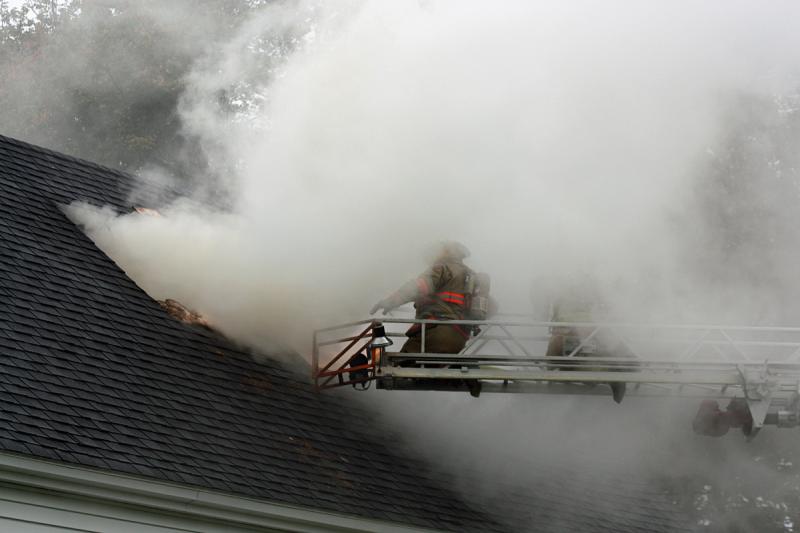 Saturday's winds whips the smoke around, momentarily shrouding firefighters before clearing again. (Photo by Holly S. Edwards)