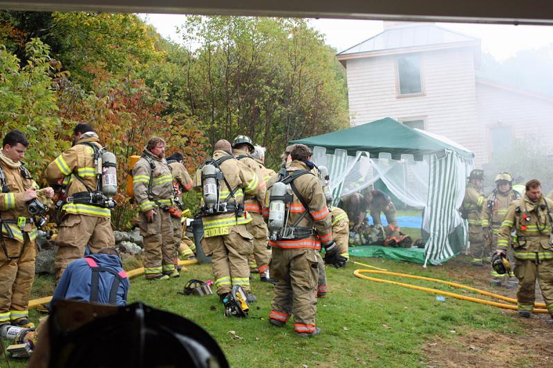 Between evolutions, firefighters wait their turn mingling or head to the rehab tent for more extensive rest and hydration. (Photo by Holly S. Edwards)