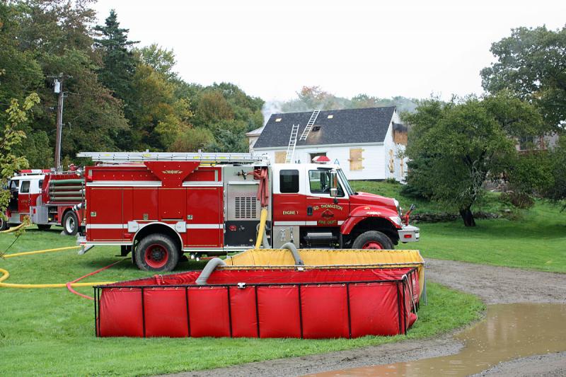 Water shuttled from a nearby fire pond is stored in a portable pool until its needed Saturday. (Photo by Holly S. Edwards)