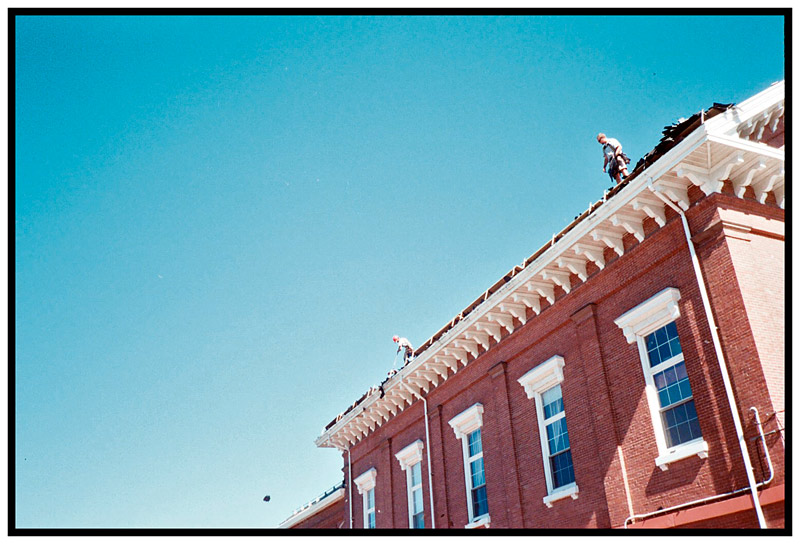 BELFAST – Workers rake shingles from the roof the Waldo County Superior Court building. Uncertainty over the state's plans for court building improvements prompted county officials to limit repairs on the building to a new roof for now.