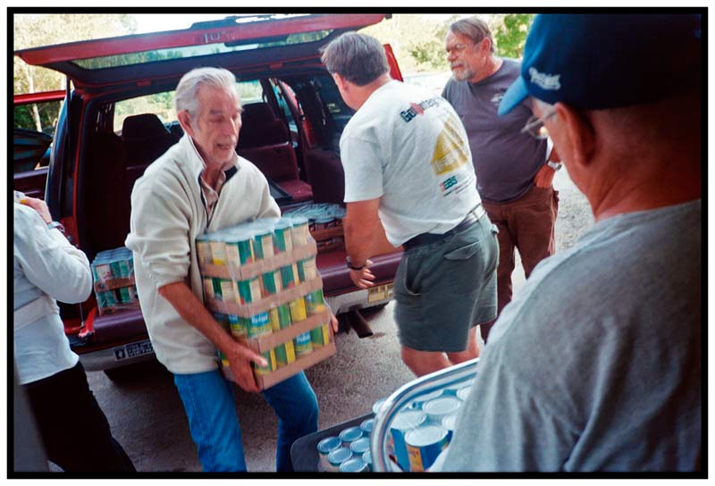 BELFAST – Volunteers outside Belfast Center unload cases of surplus canned goods from the USDA to be used in the Belfast Soup Kitchen.