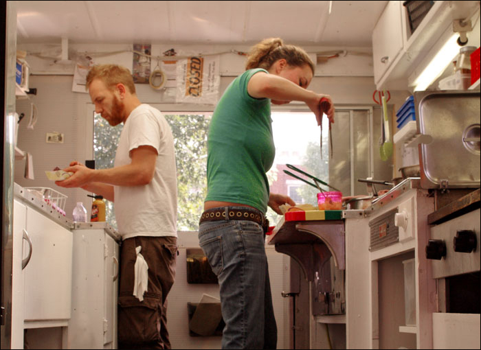 Sarah Waldron and Seth Whited, owners of Good 'n' You, side by side in the tiny kitchen.