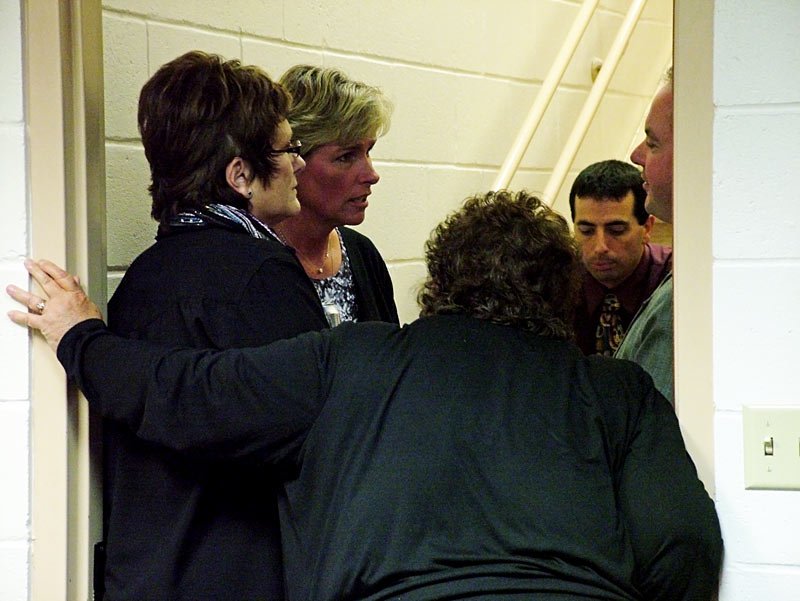 Supporters counsel Mount View Middle School teacher Eileen Ellis, second from left, during a break in a closed door session of the RSU 3 school board dealing with a grievance she filed in the spring. Ellis alleges that "bullying" by an employee ultimately forced her to take a stress-related medical leave of absence. The board heard a second grievance the same evening from teacher Ron Simmons, who cited similar treatment in his decision to switch jobs in the district. (Photo by Ethan Andrews)