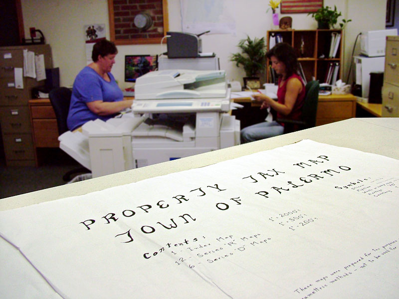 The Palermo town office was staffed by four municipal workers this time last year. Today its largely run by two, Town Clerk Sheila McCarty, background left, and Treasurer Angela Nelson, right. The change came as the result of a study that found Palermo was paying more than other municipalities for its town office. (Photo by Ethan Andrews)
