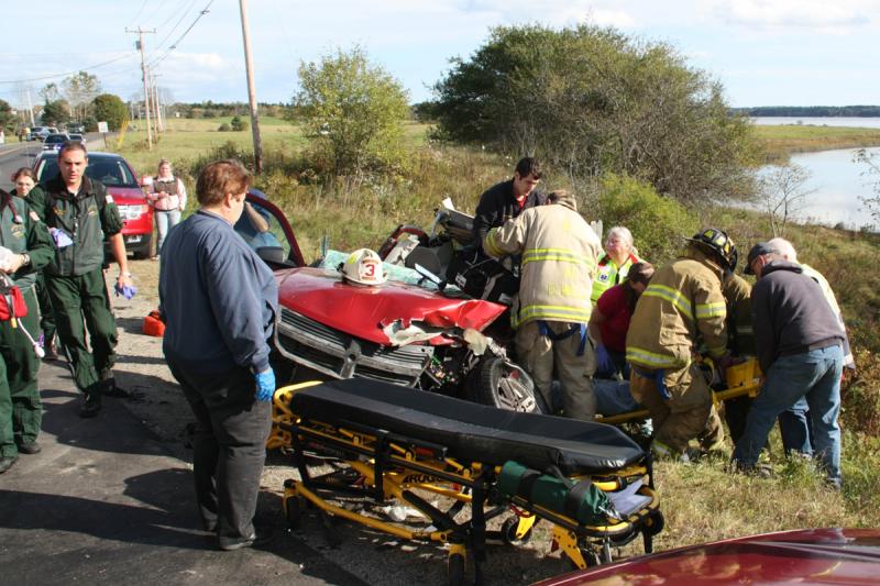 Rescue crews remove Eli Ranquist from inside his crumpled 2008 Dodge Avenger Monday afternoon in Cushing. (Photo courtesy Rockland Fire Department/Alan Athearn)