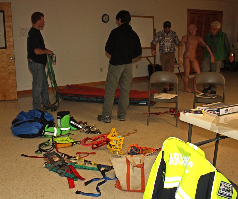 A mannikin is brought over to practice lashing, using straps and a litter. (Photo by Holly S. Edwards)