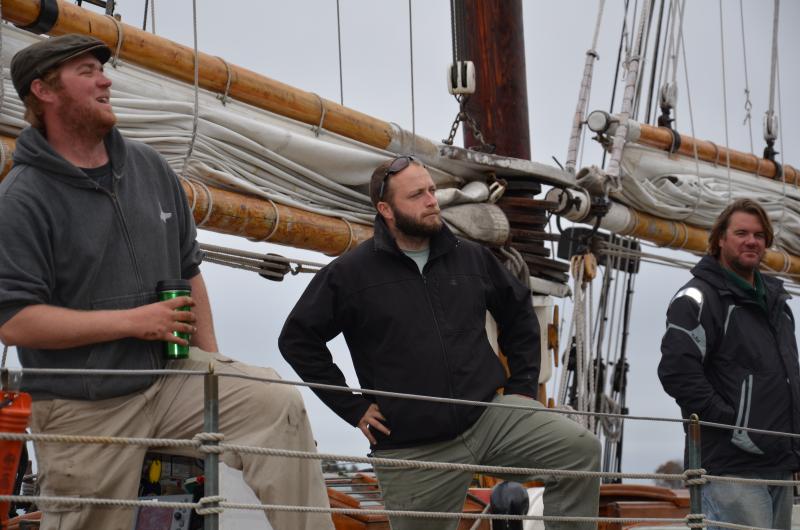 Sailors aboard the Appledore get ready to take the schooner out for one last sail on Penobscot Bay on Sunday, Oct. 28, while the breeze was light and the air just a little cool. Dylan Salzman, of Blue Hill and Key West; Jeff Beck, of Covington, Kentucky; and Jordan Smith, of Key West and the Eastern Seaboard, will tie the Appledore tonight at the Camden dock, and put an anchor out to secure the boat from banging into the dock, in case the wind blows hard out of the east, northeast. (Photo by Lynda Clancy)