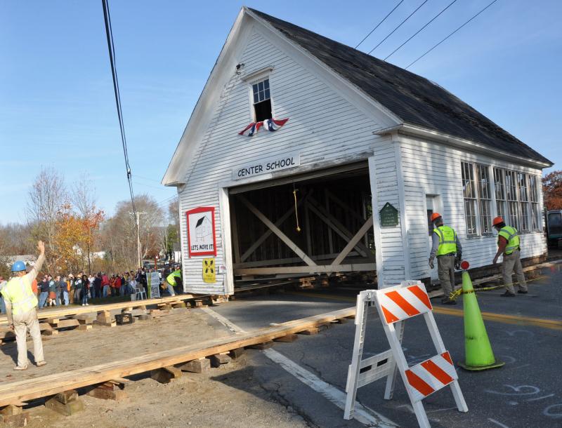 Pipe rollers and a wooden track combined block and tackle, rope and people-power to pull the old schoolhouse across the road in Lincolnville Center Saturday morning. (Photo courtesy Barbara Hatch)