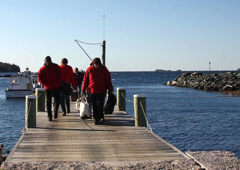 Landing on Lasell Island, radio communications operators and volunteer 'victims' head to shore to their assigned positions for the mass casualty drill Oct. 13. (Photo by Holly S. Edwards)