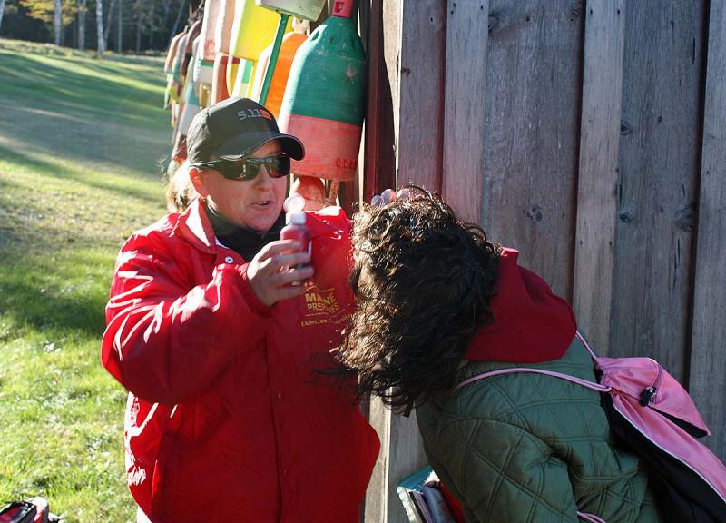 'Victim wrangler' Ellie Adams, an EMT with Camden First Aid's Association, applies fake blood to volunteer victim Amy Fowler. (Photo by Holly S. Edwards)