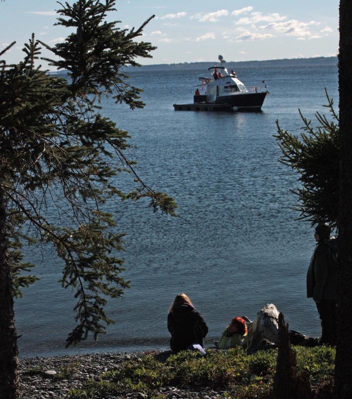 Two 'victims' of a hypothetical plane crash await rescue by real search and rescue members participating in the Oct. 13 mass casualty drill on Lasell Island. (Photo by Holly S. Edwards)