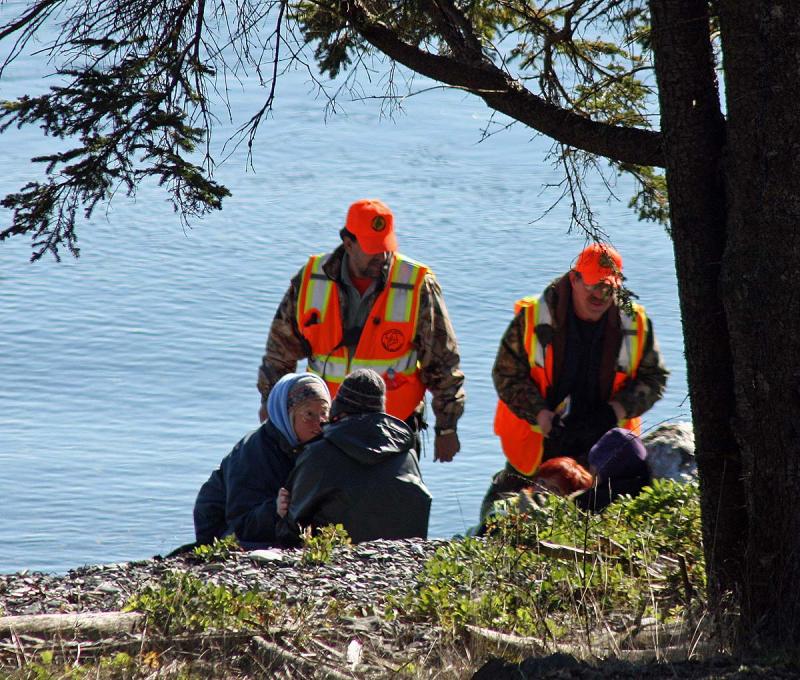 Search and rescue crews begin talking to the 'victims' of the hypothetical plane crash after discovering them on a beach Saturday morning off Penobscot Bay. (Photo by Holly S. Edwards)