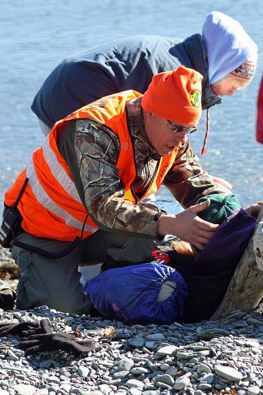 A rescuer reassures a victim and gathers information during Saturday's mass casualty drill. (Photo by Holly S. Edwards)