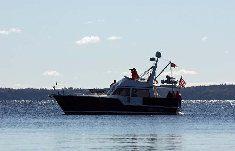 The Coast Guard Auxilliary vessel 'Dirigo Pilot' stands watch offshore Saturday morning. (Photo by Holly S. Edwards)