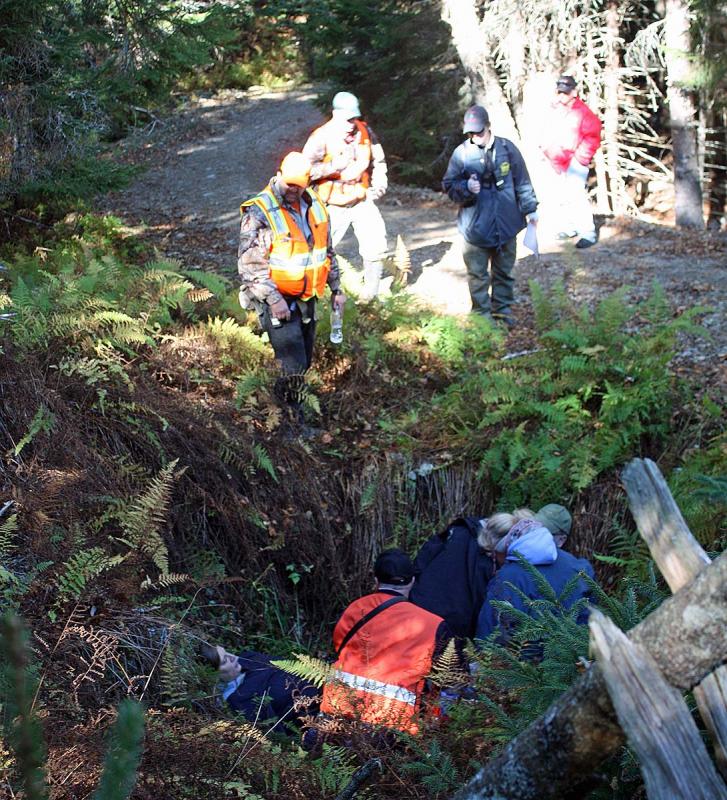 Rescuers discover two more victims in a hole south of the beach where eight other victims from a hypothetical plane crash were discovered. (Photo by Holly S. Edwards)
