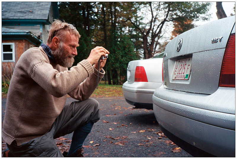BELFAST – Quentin Henderson photographs a license plate stamped "Used Car Dealer" at an auto repair shop. The resident of St. Kitts and Nevis was in Belfast visiting a friend. His collection of 1,500 odd license plates back home, he said, qualifies him as a "very small-time plate collector."