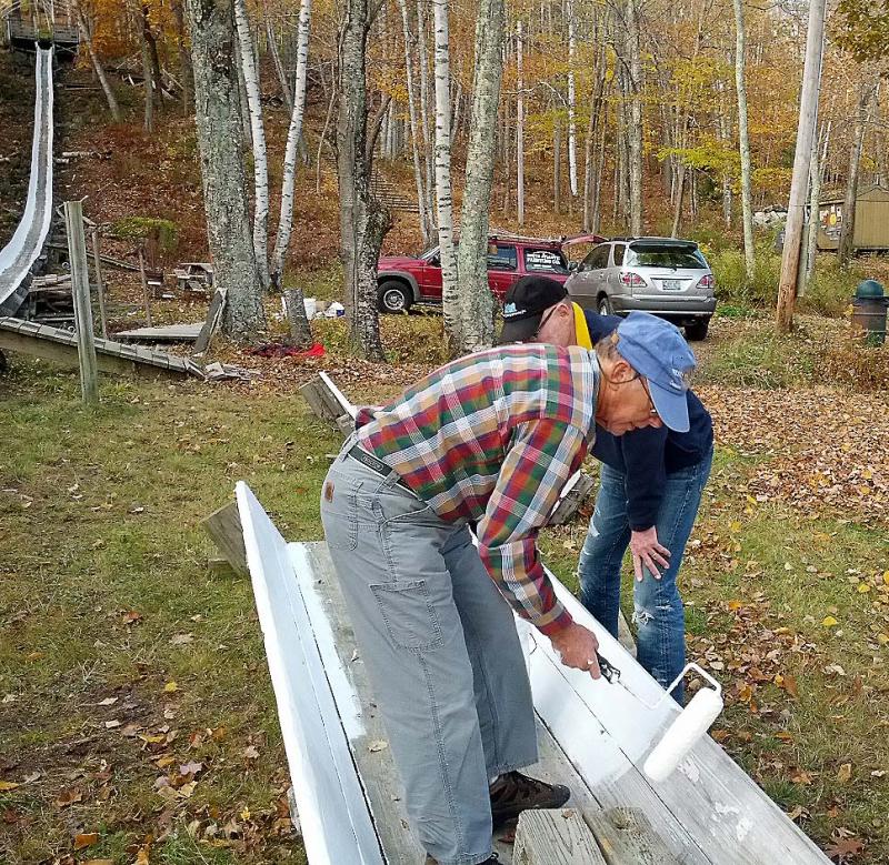 West Bay Rotarians Paul Rogers and George Forestall painting the Camden Snow Bowl's toboggan chute Oct. 26. (Photo courtesy Sandy Cox)