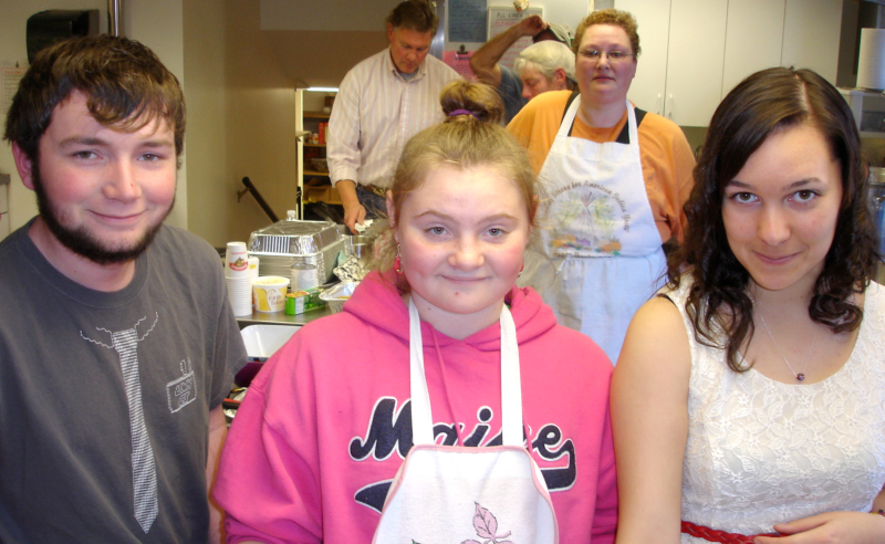 Lucia Elder’s grandchildren prepare plates for serving: Chris Lowden, of Rockland; Cassi Bennet, of Friendship; and Eve Hupper, of Rockland. Collen Elder looks on in the background.