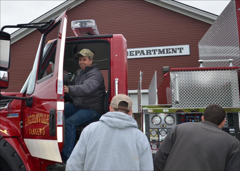 Lincolnville firefighter Todd Young tests the driver's seat. (Photo by Lynda Clancy)