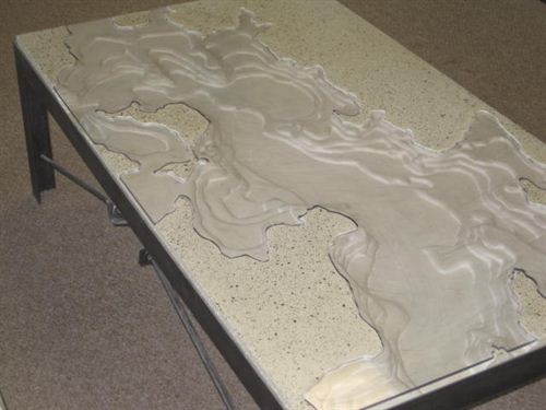 A topographical map of islesboro etched into a concrete coffee table. (photo: Alternative Rock, LLC) alternative rock, llc, pechakucha