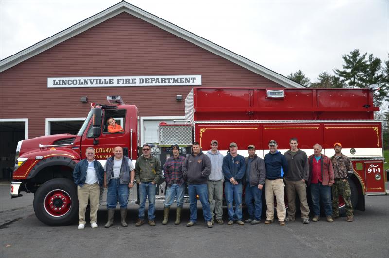 Lincolnville firefighters on hand to welcome the new truck were: Millard Eugley, Hank Lang, Mike Eugley, Brian Englander, Assistant Chief Peter Rollins, A.J. Weed, Assistant Chief Don Fillington, Todd Young, Chief Jason Peasley, Orrin Todd, Robert Libby and Brandon Allen. (Photo by Lynda Clancy)